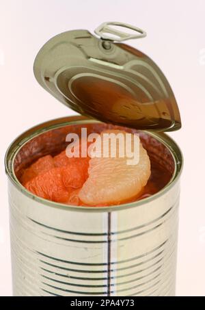 A can of mixed Grapefruit segments in a un-wrapped tin on a white background. Stock Photo