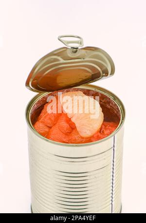 A can of mixed Grapefruit segments in a un-wrapped tin on a white background. Stock Photo