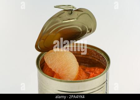 A can of mixed Grapefruit segments in a un-wrapped tin on a white background. Stock Photo