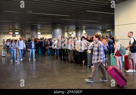 Inside check in area of Gran Canaria Airport with queue of passengers waiting, Spain Stock Photo
