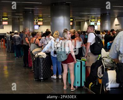 Inside check in area of Gran Canaria Airport with queue of passengers waiting, Spain Stock Photo