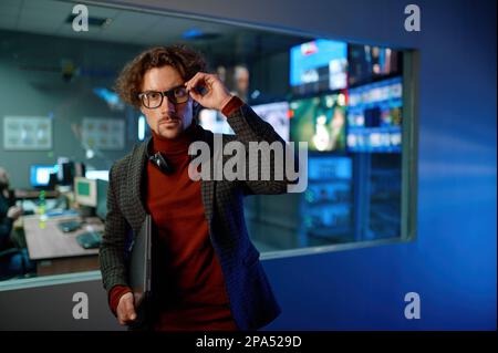 System administrator in eyeglasses in server datacenter hall Stock Photo