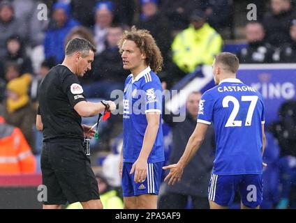 Referee Andre Marriner shows a red card to Leicester City's Wout Faes during the Premier League match at the King Power Stadium, Leicester. Picture date: Saturday March 11, 2023. Stock Photo
