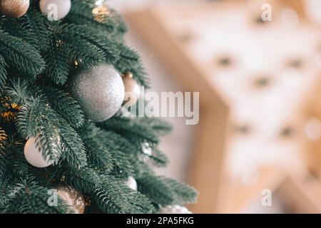 Christmas and New Year decorated interior room. Holiday decorated room with bed on window sill. Stock Photo