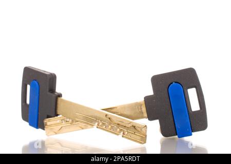 Two metal keys from a door lock, macro, isolated on white background. Stock Photo