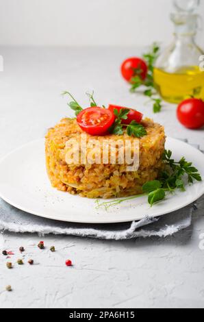 Rice with Cabbage and Ground Meat on a Plate, Lazy Unstuffed Cabbage Rolls on Bright Background Stock Photo