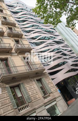 Conceptual avant-garde building opposite Gaudi's La Pedrera, possibly luxury apartments,Suites Avenue Hotel. It is the old juxtaposed with the new . Stock Photo