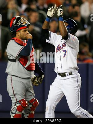 New York Mets' Jose Reyes points to the sky crossing the plate