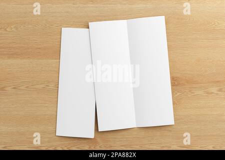 Half-folded flyer A4 vertical booklet mock up on wooden background. View directly above Stock Photo