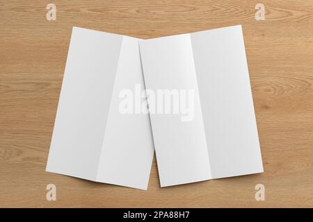Half-folded flyer A4 vertical booklet mock up on wooden background. View directly above Stock Photo
