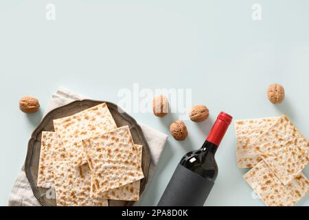 Matzah traditional ritual Jewish bread in plate on blue background. Pesach Jewish holiday. Passover food and celebration concept. Top view. Copy space Stock Photo