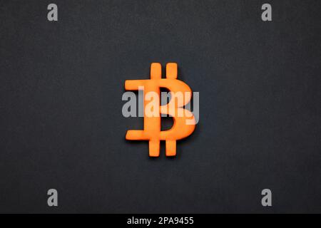 Symbol of bitcoin crypto currency. 3d Golden bitcoin sign on black background concept.   Financial market and investment. Stock Photo