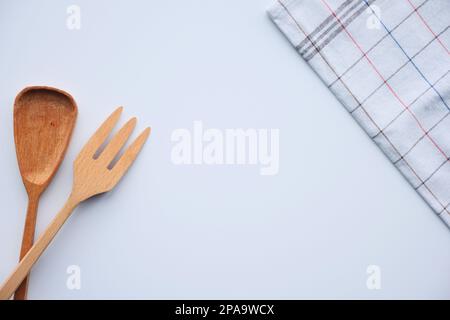 wooden cutlery fork and spoon with table cloth on white background  Stock Photo