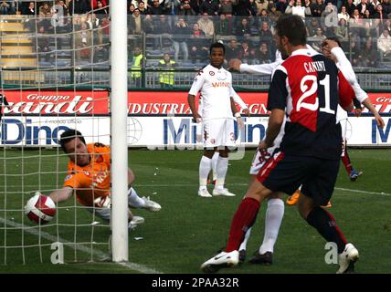 Cagliari s Michele Canini right n. 21 looks at the ball go in