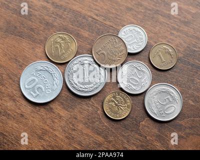 Polish metallic money on wooden table, close up. Zloty and groszy coins, selective focus Stock Photo