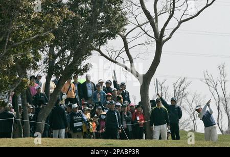 K.J. Choi of South Korea, right, watches his a shot during the