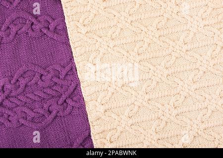 Two knitted fabrics in lilac and beige. Close-up of a knitted blanket. Abstract minimal knitted background. Copy space Stock Photo