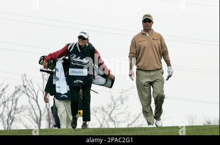 Chris DiMarco, right, of the United States walks with his wife and