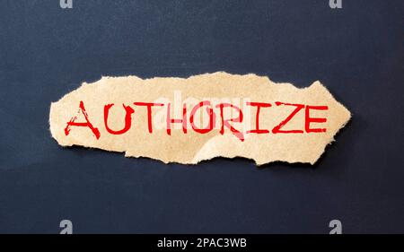 the word authorized is written a white sheet of paper which lies on a delto-white background next to a computer and a calculator. High quality photo Stock Photo