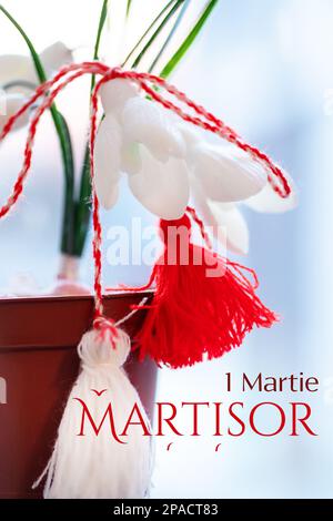 martisor and snowdrops Galanthus nivalis. Postcard for the holiday of spring and Baba Marta. Hi spring. Red and white talisman of friendship and love. Stock Photo