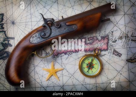 Pirate Pistole On Old Map With Compass and Starfish Still Life Stock Photo