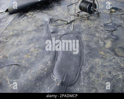 HDPE landfill liner patch installed on a bad weld seam. Stock Photo