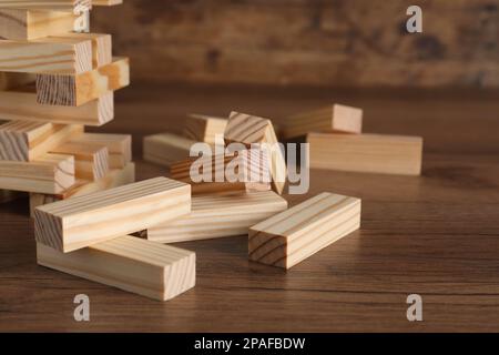 Wooden Jenga blocks on table, closeup. Board game Stock Photo