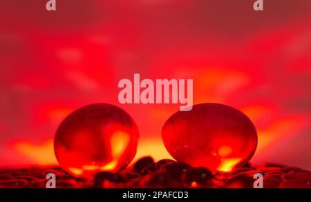 Easter eggs on black stones with colorful background. Neon lights effect. Front view. Minimal concept. Stock Photo