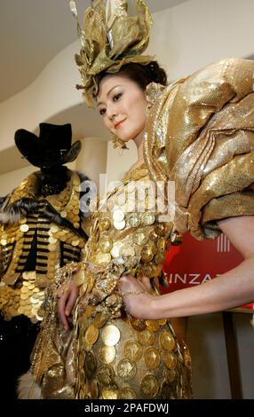 A model displays a gold dress featuring 325 gold Vienna Philharmonic coins  worth 28,670,410 yen ($267,948) at Ginza Tanaka jewelry shop in Tokyo  Thursday, Feb. 14, 2008. Being Japan's sole agent for