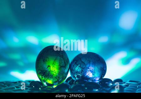 Easter eggs on black stones with colorful background. Neon lights effect. Front view. Minimal concept. Stock Photo