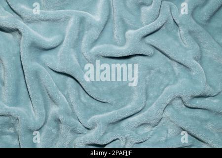 Wavy soft blue fabric texture background, made with  Blanket. Top view with Copy space. Minimal concept. Stock Photo
