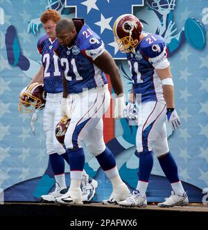 Washington Redskins Chris Cooley, with a No. 21 on his jersey, catches a  short pass and is tackled by Bills linebacker Keith Ellison during the 2nd  quarter of game on December 2