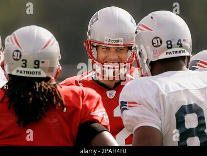 New England Patriots quarterback Tom Brady (12) wipes the sweat off his  face during practice on the second day of training camp at the NFL football  team's facility in Foxborough, Mass., Friday