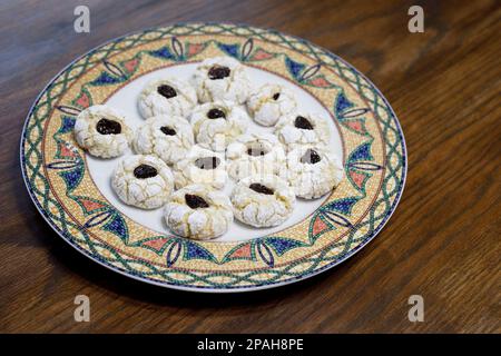 Plate of fresh homemade lemon cookies with dried cherries on top, baked with almond flour.  A bakers dozen (thirteen). Stock Photo