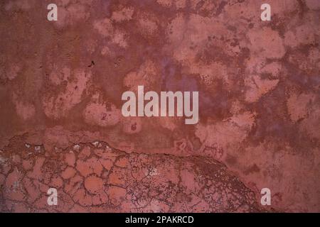 The texture of an old rustic wall is covered with pink stucco Stock Photo