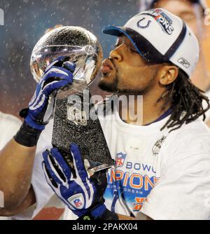 Indianapolis Colts Bob Sanders kisses the Vince Lombardi trophy as coach  Tony Dungy, his wife and Peyton Manning look on at Super Bowl XLI at  Dolphin Stadium in Miami on February 4