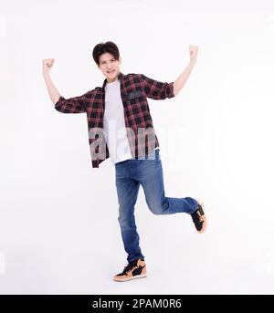Excited young man dancing and jumping  with success gesture Stock Photo