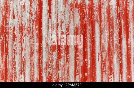 Red painted weathered corrugated sheets for a background, texture, overlay. Stock Photo