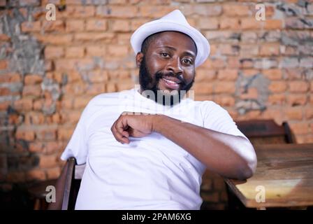 Looking relaxed. a ethnic man relaxing indoors. Stock Photo