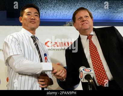 Japanese free agent outfielder Kosuke Fukudome, left, shows his new team  jersey with the Chicago Cubs manager Jim Hendry at Wrigley Field,  Wednesday, Dec. 19, 2007, in Chicago. (AP Photo/Nam Y. Huh