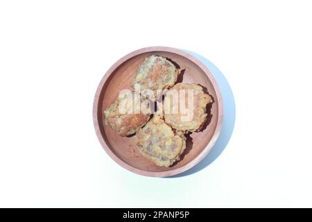 a close up of a bowl of fried stuffed tofu isolated on white background. Indonesian food concept. Stock Photo