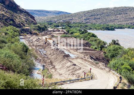 Boegoeberg Dam, South Africa - Feb 28 2023: Backhoe loaders clearing sand that blocked the irrigation canal originating from the Boegoeberg Dam. The f Stock Photo