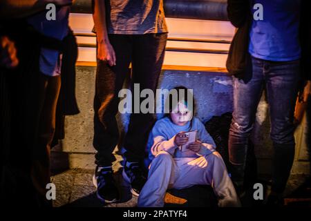 Tel Aviv, Israel. 11th Mar, 2023. A kid looks at her phone during the demonstration. Protesters took to the streets, as anti-judicial reform protests entered their tenth consecutive week. (Photo by Eyal Warshavsky/SOPA Images/Sipa USA) Credit: Sipa USA/Alamy Live News Stock Photo