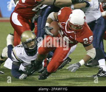 Miami Ohio running back Austin Sykes (29) is brought down by Akron  defensive back Davanzo Tate (5) in the first quarter during their football  game Wednesday, Nov. 14, 2007, in Oxford, Ohio. (