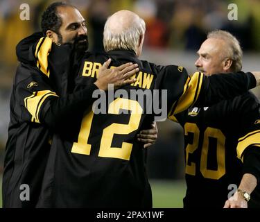 Pittsburgh Steelers Hall of Famers Franco Harris, left, and Terry Bradshaw,  12, and running back Rocky Bleier, 20, are honored at half-time of a NFL  football game against the Baltimore Ravens as