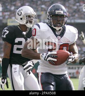 Oakland Raiders' Fabian Washington, (27), hangs his head as teammate  Michael Huff watches the replay of San Diego Chargers' LaDainian  Tomlinson's fourth touchdown during their NFL football game Sunday, Oct.  14, 2007