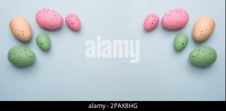 Frame from multicolored eggs on blue background.Easter concept. Stock Photo