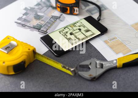 website wireframe sketch and programming code on smartphone Stock Photo