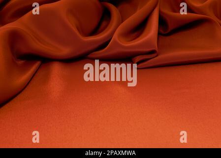 texture of crumpled fabric of red or orange color. Canvas. Textile. Material chintz or satin Stock Photo