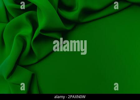 Texture, background, pattern. Texture of green silk fabric. Beautiful emerald green soft silk fabric Stock Photo